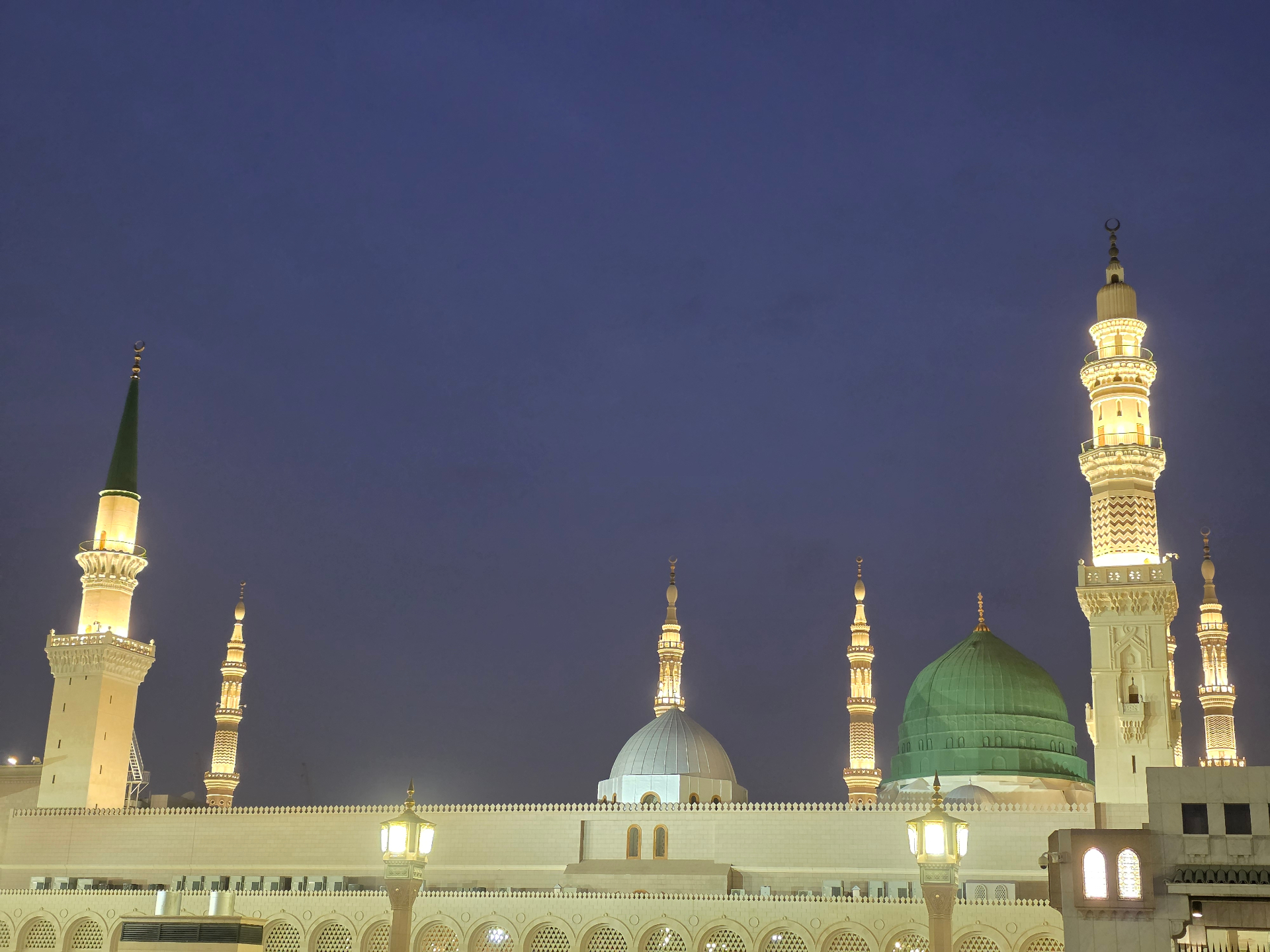 Masjid an-Nabawi at night, with illuminated minarets and the Green Dome
